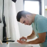 Disabled man with down syndrome in bathroom